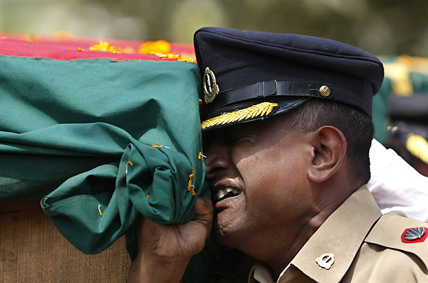 An army soldier cries as he carries the coffin of a Bangladesh Rifles officer during a state funeral for officers killed in the recent mutiny in Dhaka.

