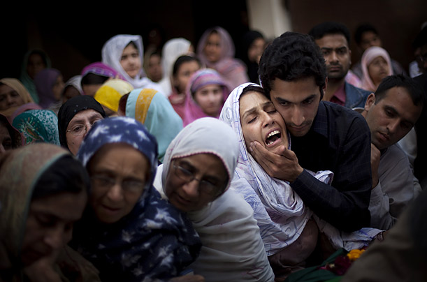 Relatives mourn Raheel Fayz, one of the policemen killed during Monday's attack on a police academy in Lahore, Pakistan.

