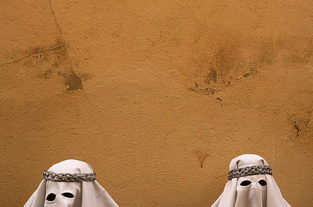 Penitents take part in a procession of the Gitanos brotherhood during Holy Week in the Andalusian city of Malaga, southern Spain