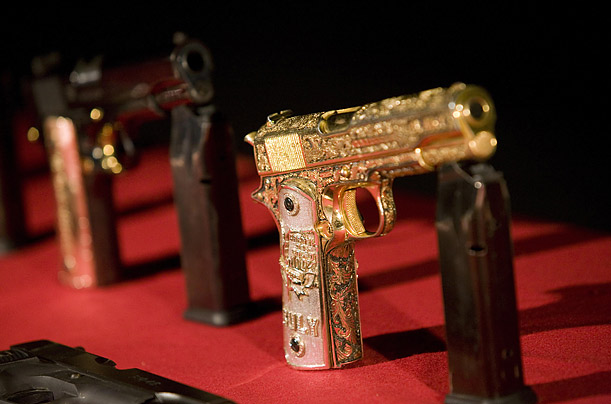 Pistols seized from suspected drug gang hitmen are displayed to the media at a military base near Monterrey, Mexico.