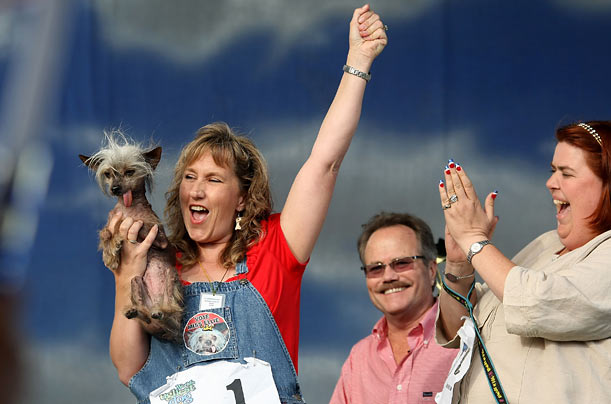 Dawn Goehring of Gatlinburg, Tennessee, celebrates with her dog Miss Millie, a Chinese Crested, after winning the pedigree