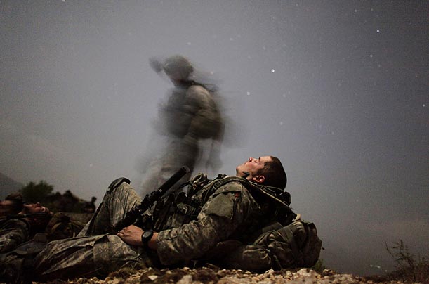 A U.S. soldier from the Task Force Mountain Warrior takes a break during a night mission near the Pesh Valley.