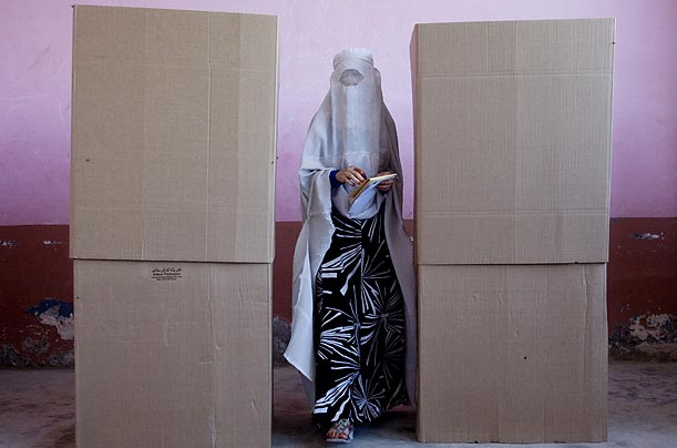 A woman casts her ballots in the Afghan presidential election at a polling station in Mazar-i-Sharif.