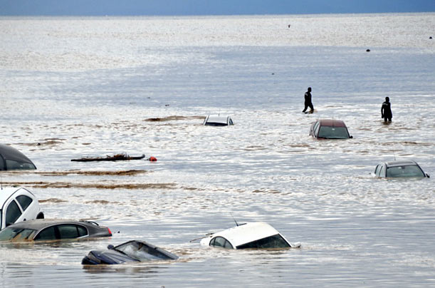 People walk across a flooded highway in Istanbul