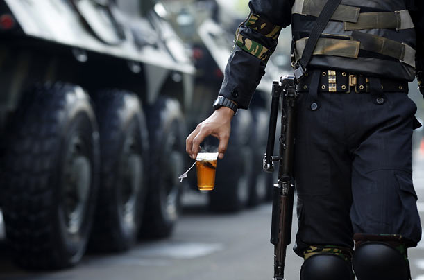 Tea Party
An Indonesian soldier carries a cup of tea as he helps provide security during President Susilo Bambang Yudhoyono's