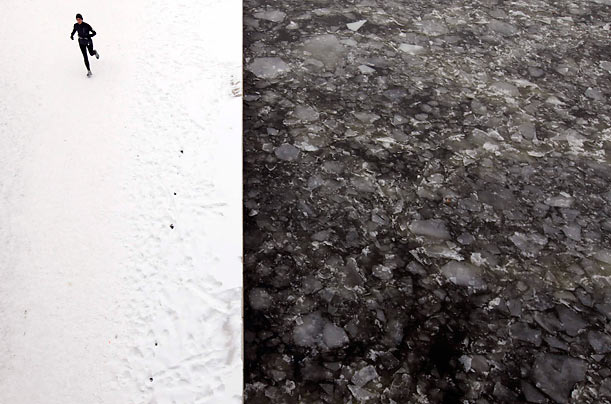 Hustle and Ice Flow
A woman runs along the snow covered banks of the frozen Spree river in Berlin.