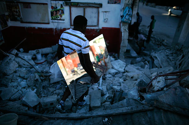 Unbroken
Haitian barber Raymond Matin retrieves a mirror from the rubble of his shop in downtown Port-au-Prince.