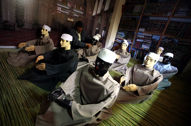 A worker adjusts an exhibit inside a new museum about Palestinian life in the West Bank city of Jenin.