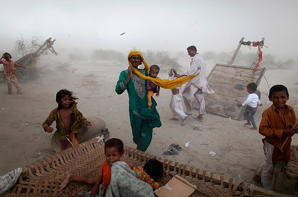 Flood victims look for shelter as a storm hits their encampment in
Pakistan's Muzaffargarh district of Punjab province.