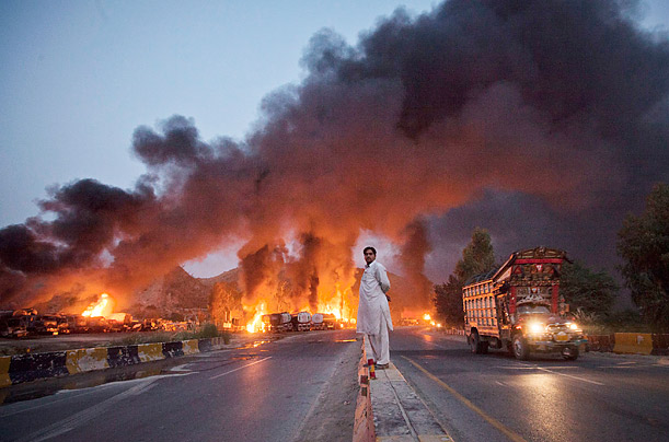 Crash and Burn

A local resident stands on a street median as he watches fuel tankers burn along the GT road in Nowshera, Pakistan. Gunmen in Pakistan set fire to up to 40 NATO supply trucks headed for Afghanistan.