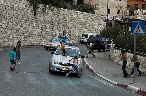 An Israeli motorist runs down a masked Palestinian youth who was standing among a group of youngsters throwing stones at Israeli cars in the mostly Arab east Jerusalem neighborhood of Silwan.  



