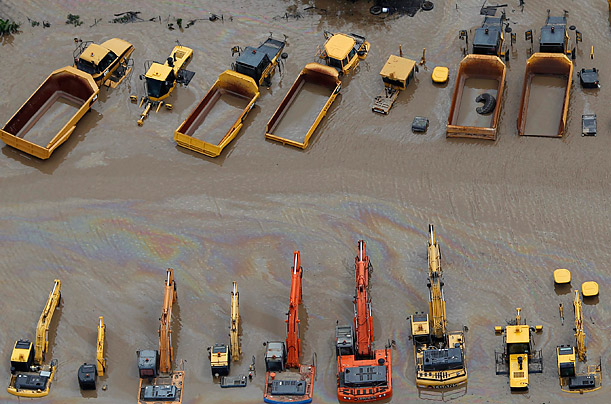 Heavy equipment is submerged in flood waters in an industrial area of Brisbane, Austrailia.